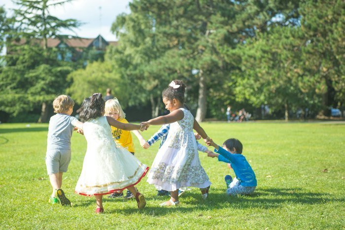 Children holding hands in a park