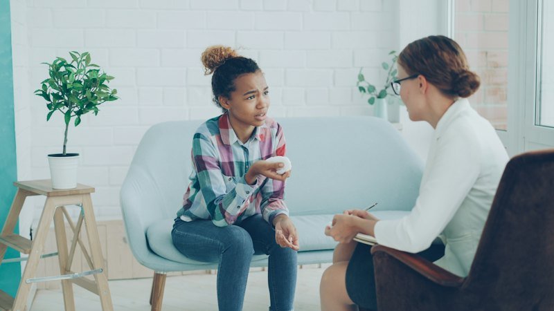 Counselor talking with a young girl