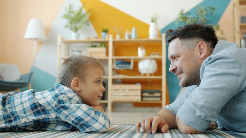 Father and son talking on the floor