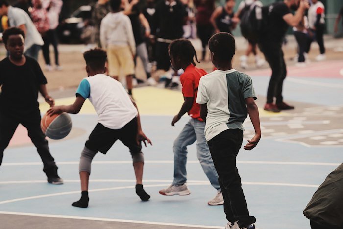 Children playing basketball at school