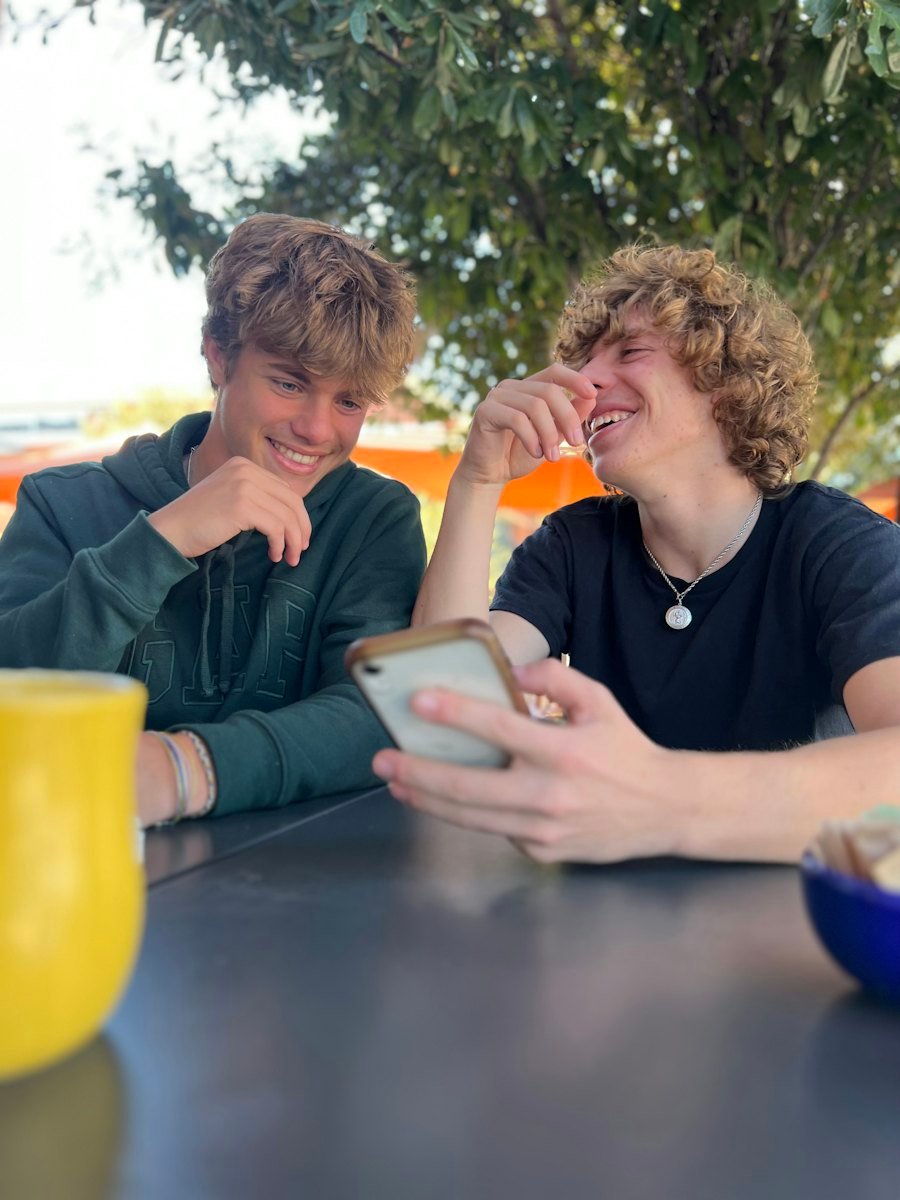 Two teenagers laughing together